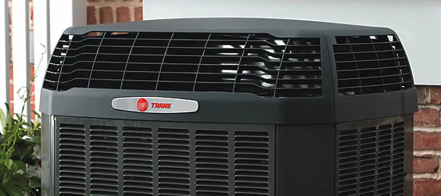 Trane outdoor air conditioning unit beside a home