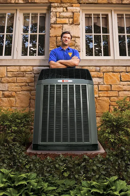 Trane dealer standing behind a commercial AC unit
